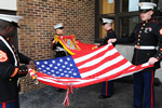 Team packing up flag after a ceremony